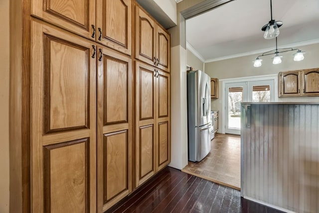 kitchen with ornamental molding, dark wood-type flooring, brown cabinets, and stainless steel fridge with ice dispenser