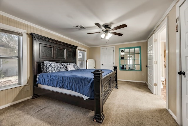 bedroom with light carpet, baseboards, visible vents, ceiling fan, and ornamental molding