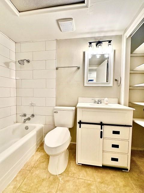 full bathroom featuring shower / bathtub combination, toilet, visible vents, vanity, and tile patterned floors