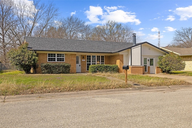 ranch-style home featuring a front yard and brick siding