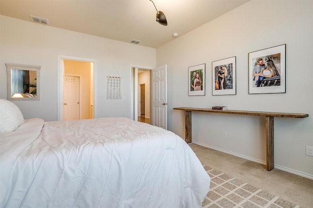 bedroom featuring baseboards, visible vents, and light colored carpet