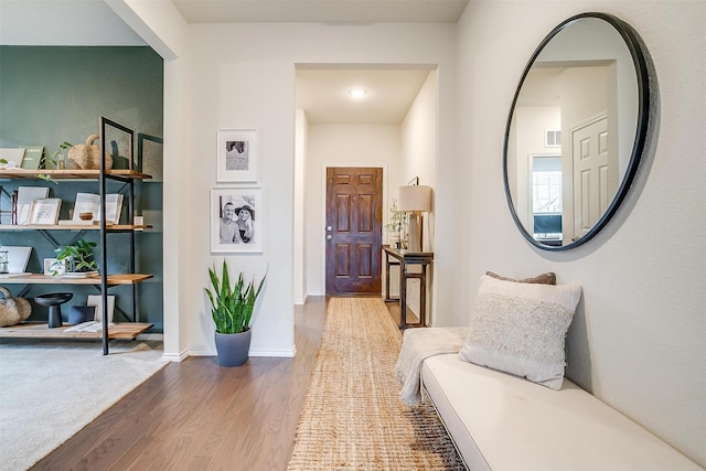 interior space with baseboards and wood finished floors