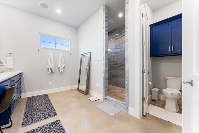 bathroom featuring a stall shower, toilet, vanity, and baseboards