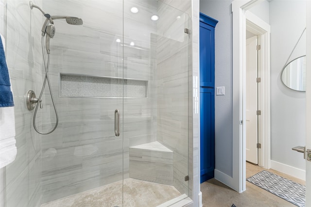 bathroom featuring a stall shower and baseboards