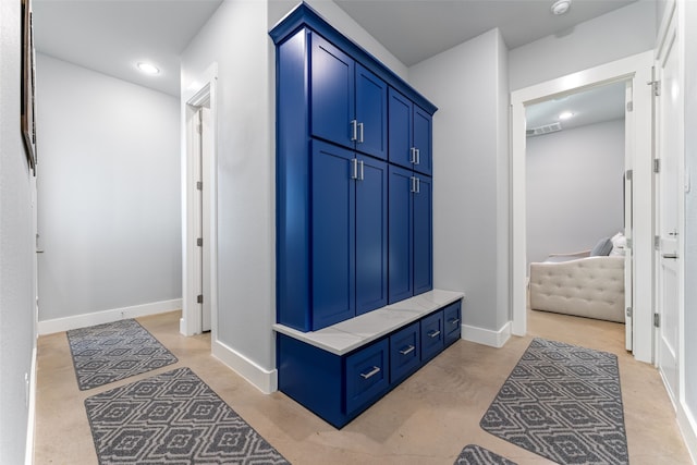 mudroom featuring finished concrete flooring, baseboards, visible vents, and recessed lighting