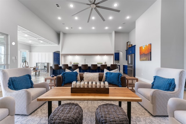 living room with baseboards, visible vents, and recessed lighting