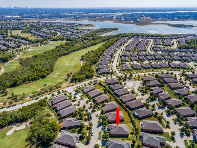 aerial view featuring a water view, view of golf course, and a residential view