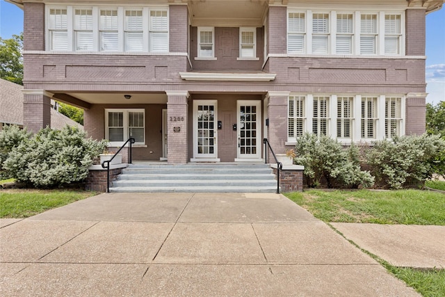 view of front facade featuring a porch and brick siding