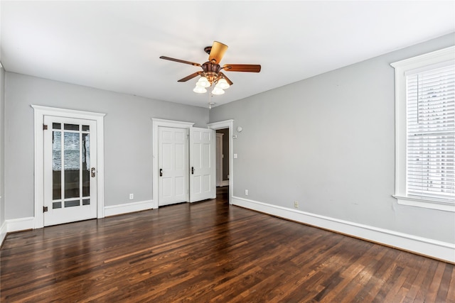 unfurnished bedroom with ceiling fan, baseboards, and wood finished floors