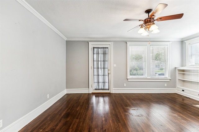 empty room with ornamental molding, ceiling fan, baseboards, and hardwood / wood-style flooring