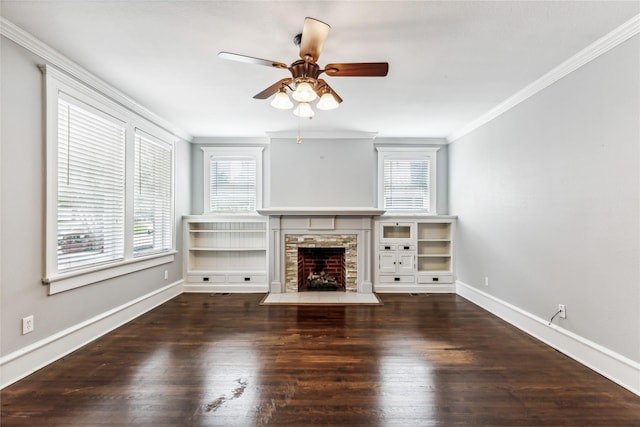 unfurnished living room featuring baseboards, wood finished floors, and crown molding