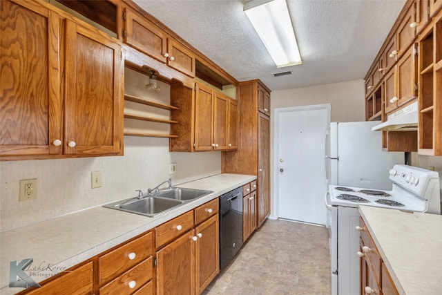 kitchen with open shelves, light countertops, visible vents, a sink, and white appliances