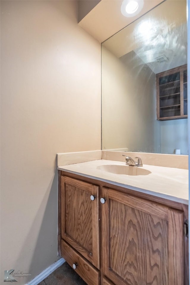 bathroom featuring baseboards and vanity