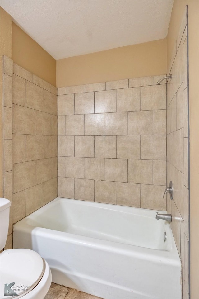 full bath featuring a textured ceiling, shower / bathing tub combination, and toilet