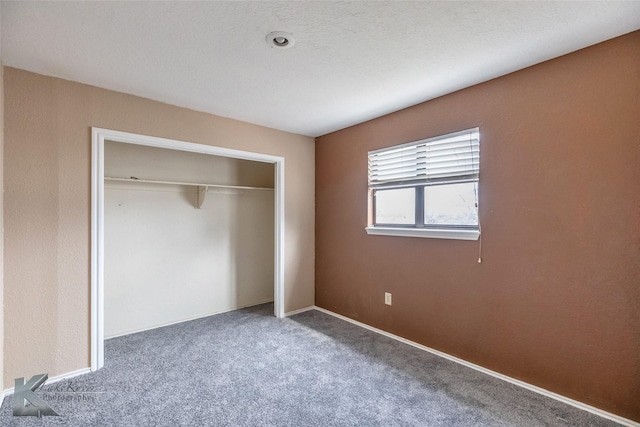 unfurnished bedroom featuring a closet and carpet