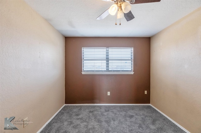 spare room featuring carpet, baseboards, and a textured ceiling