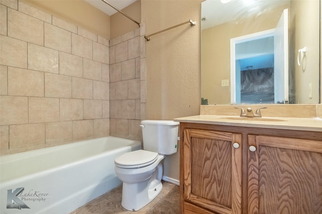 bathroom with bathing tub / shower combination, vanity, toilet, and tile patterned floors