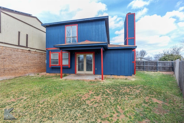 back of house with a yard, french doors, a patio, and a fenced backyard