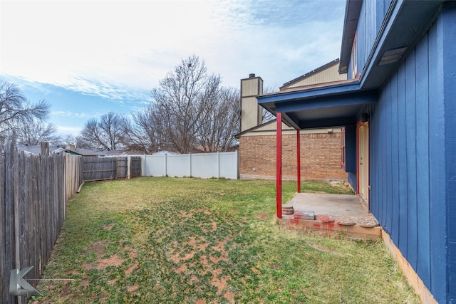 view of yard featuring a patio area and a fenced backyard