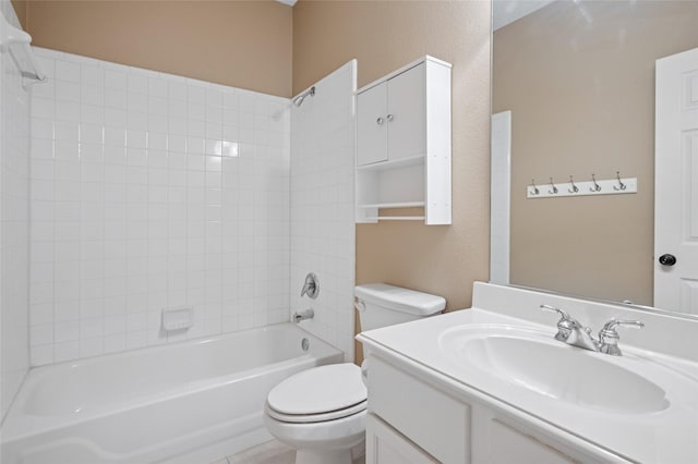 bathroom with tub / shower combination, vanity, and toilet