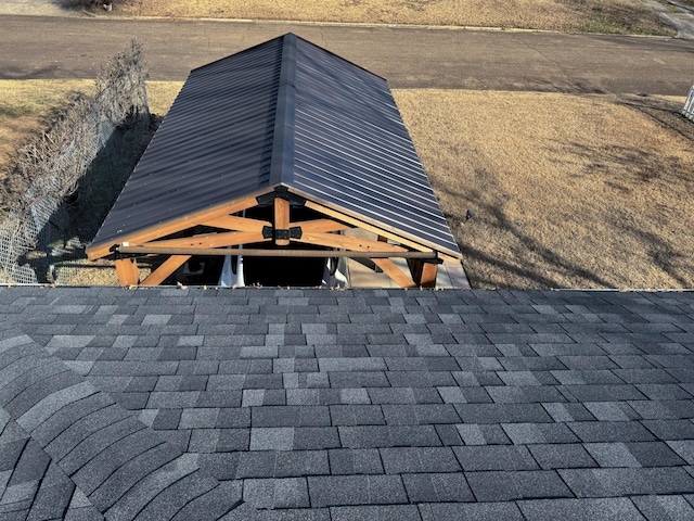 exterior details featuring roof with shingles