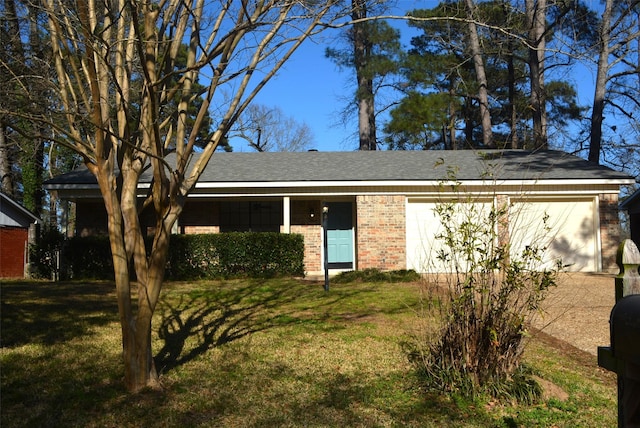 ranch-style home featuring a garage, a front lawn, and brick siding