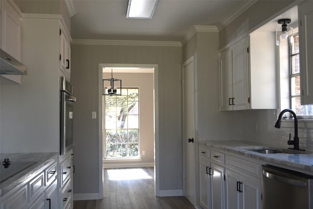 kitchen with crown molding, stainless steel appliances, a sink, and white cabinets