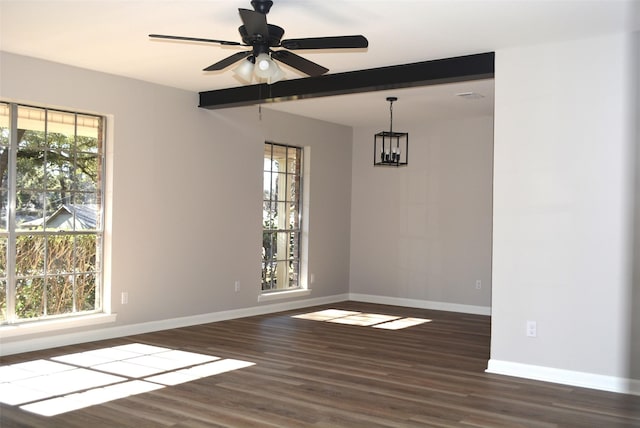 unfurnished room featuring ceiling fan with notable chandelier, baseboards, a wealth of natural light, and wood finished floors