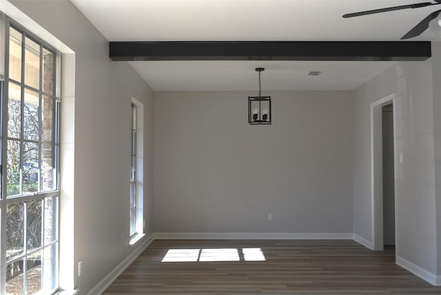 unfurnished room with dark wood-style floors, a ceiling fan, beam ceiling, and baseboards