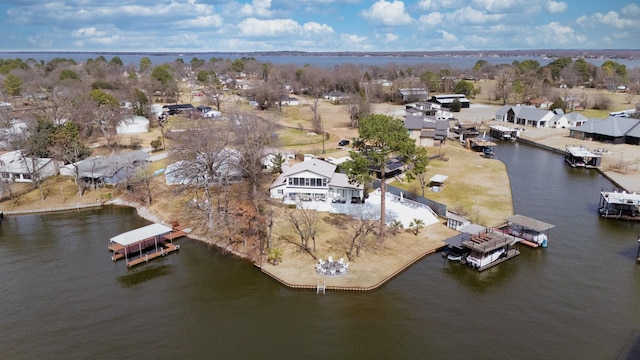 drone / aerial view featuring a residential view and a water view