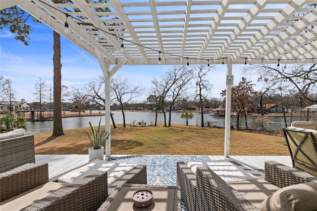 view of patio / terrace with a deck with water view and a pergola