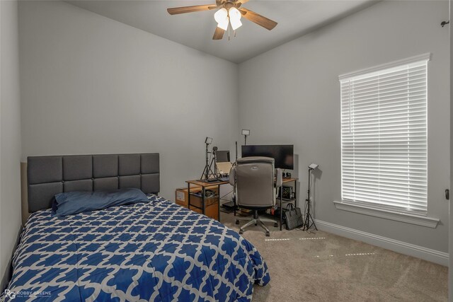 carpeted bedroom featuring a ceiling fan and baseboards