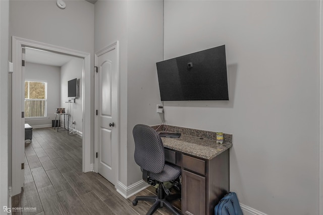 office with baseboards and wood tiled floor