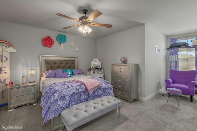 carpeted bedroom with a ceiling fan and baseboards