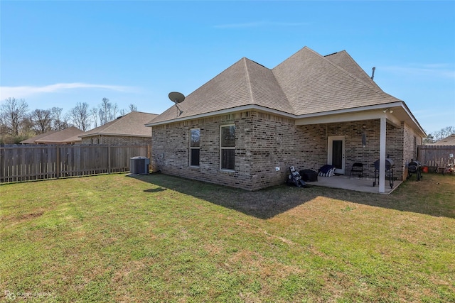 back of property featuring a patio area, a fenced backyard, cooling unit, and a yard