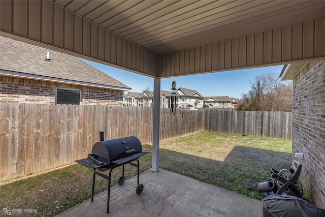 view of patio with grilling area and a fenced backyard