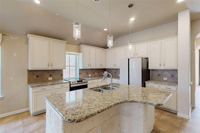 kitchen with freestanding refrigerator, white cabinets, a sink, and stainless steel electric range