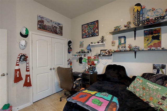 bedroom featuring a closet and light tile patterned flooring