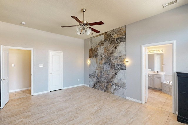 unfurnished bedroom featuring a ceiling fan, baseboards, visible vents, and a sink