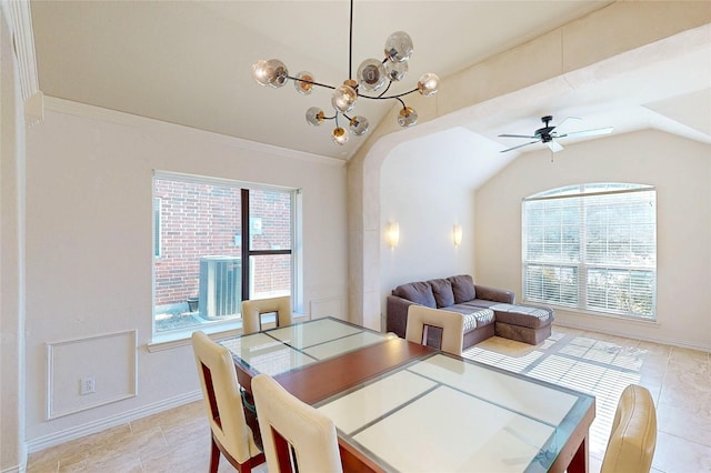 dining area with lofted ceiling, ceiling fan with notable chandelier, and a healthy amount of sunlight