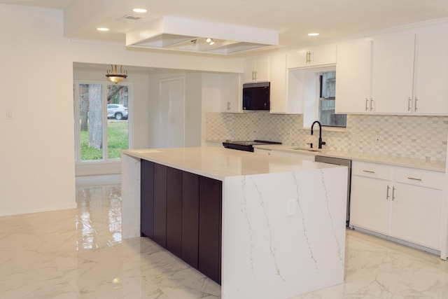 kitchen with a kitchen island, marble finish floor, black appliances, white cabinetry, and a sink