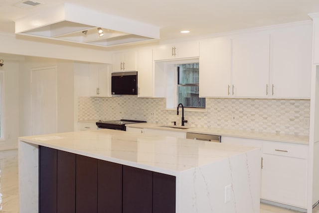 kitchen with a kitchen island, white cabinets, a sink, and black / electric stove