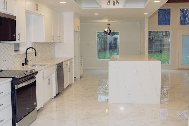 kitchen with white cabinets, marble finish floor, stainless steel appliances, a chandelier, and a sink