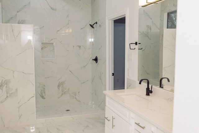 bathroom featuring marble finish floor, vanity, and a marble finish shower