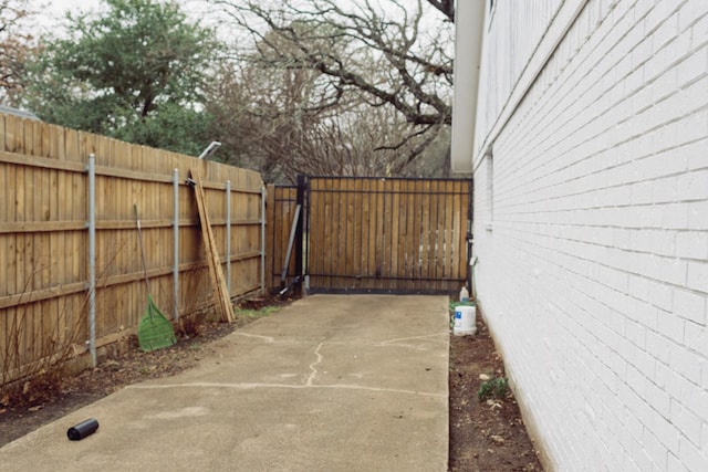 view of patio / terrace featuring fence and a gate