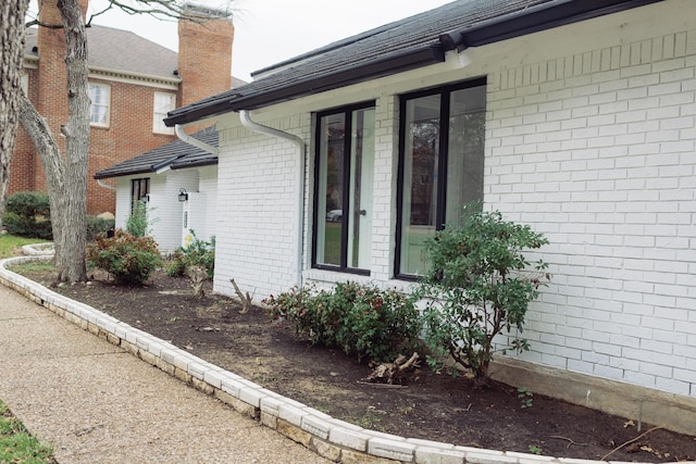 view of side of home with brick siding