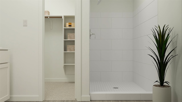 full bathroom featuring a stall shower and baseboards