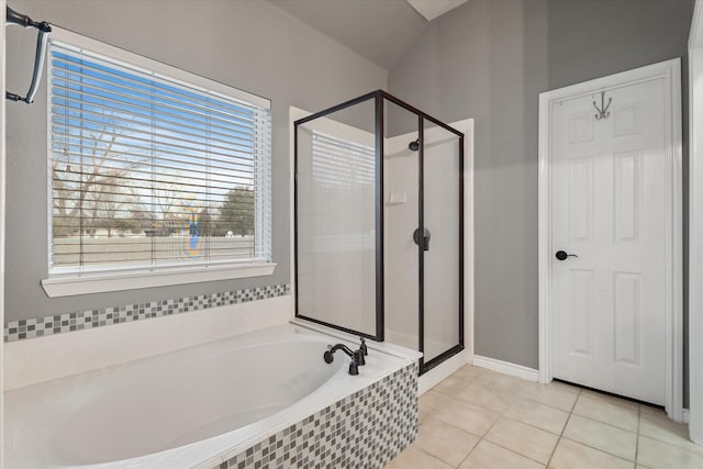 bathroom featuring a garden tub, a stall shower, and tile patterned flooring