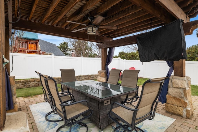 view of patio with outdoor dining area, a fenced backyard, and a ceiling fan