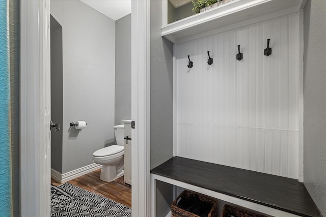 mudroom featuring dark wood finished floors and baseboards